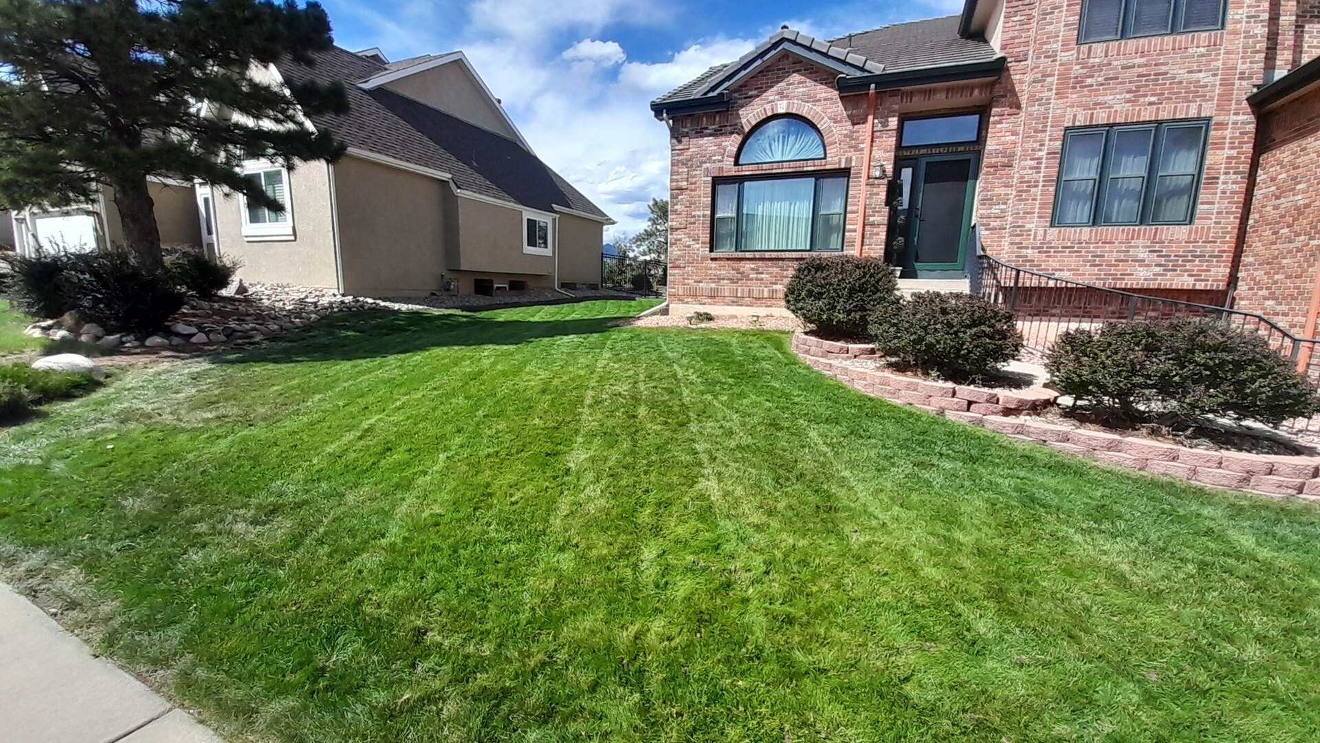 Freshly mowed front lawn with visible mowing lines